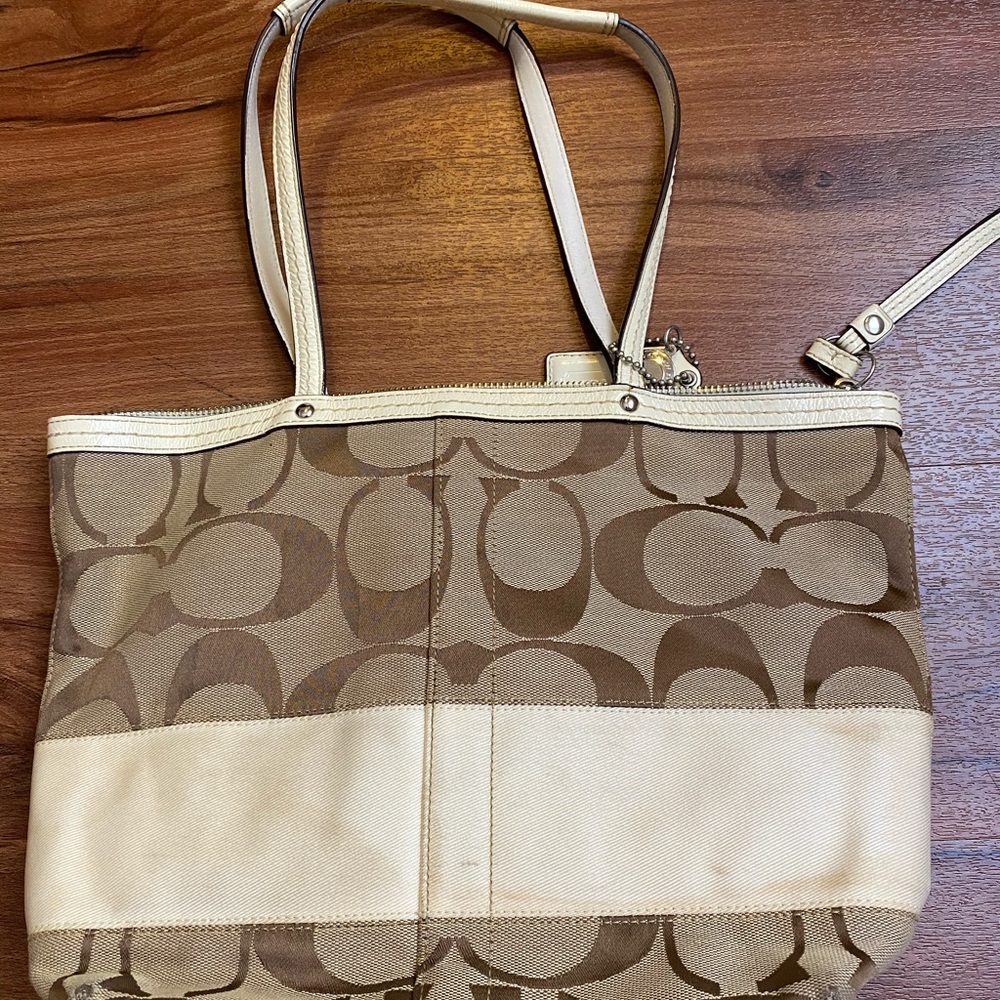 White and tan over the shoulder Coach bag